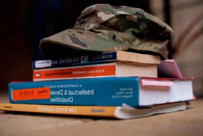 A military hat on textbooks.